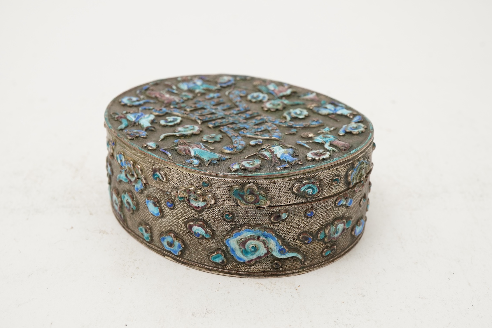 A Chinese silver plated and enamel ‘eight immortals’ oval box, late 19th century